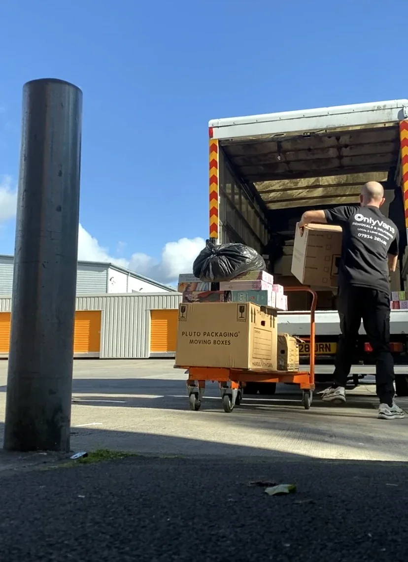 OnlyVans worker loading boxes into a Luton van